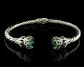8031BG-BT	18K Gold & sterling silver blue topaz bangle 


